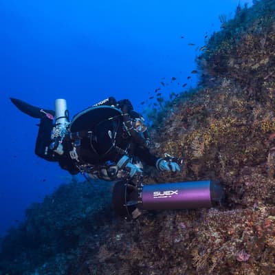 A diver following a coral wall with the Goldfinder DPV