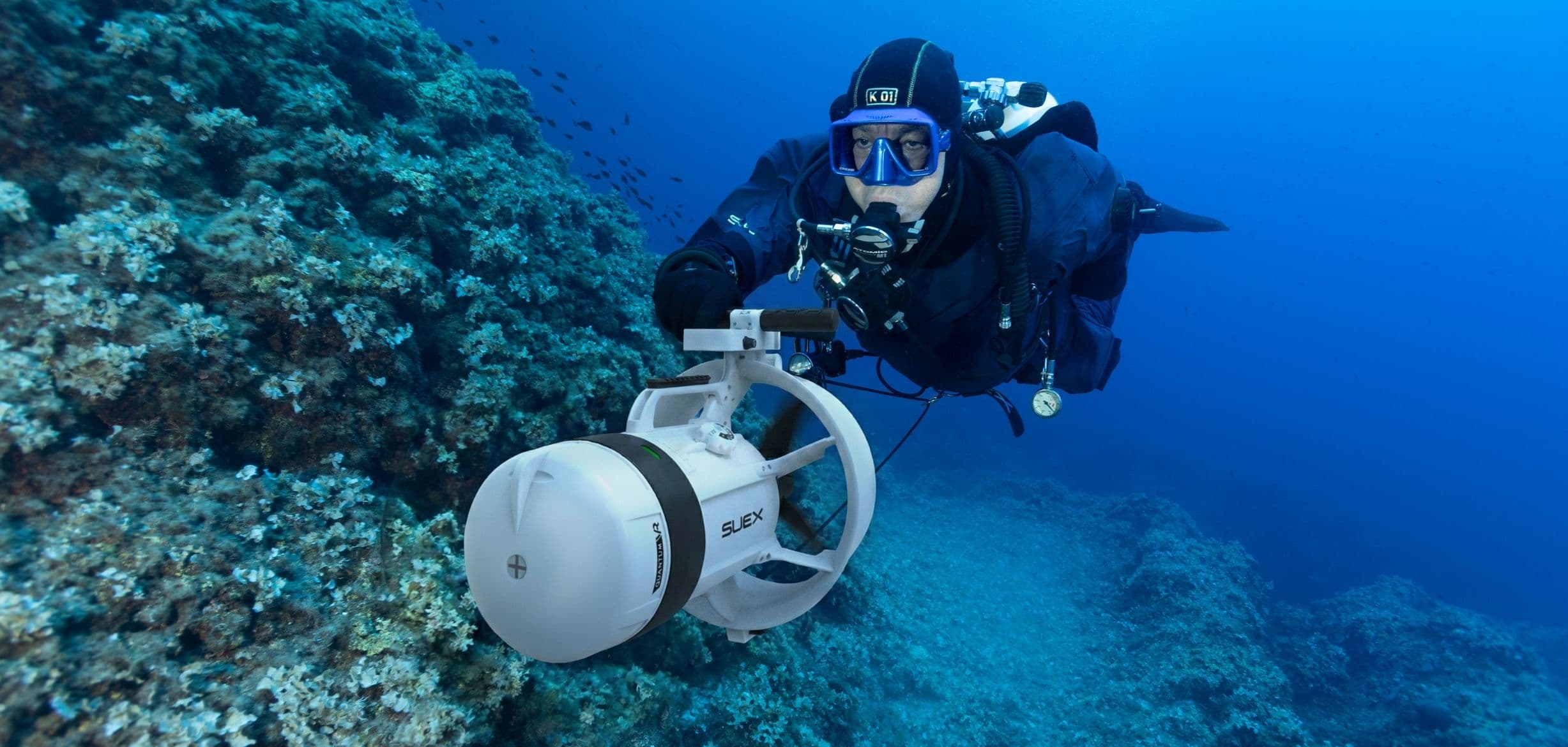 Taucher mit dem QUANTUM VR DPV in der limitierten Ice White Edition an einer Korallenwand